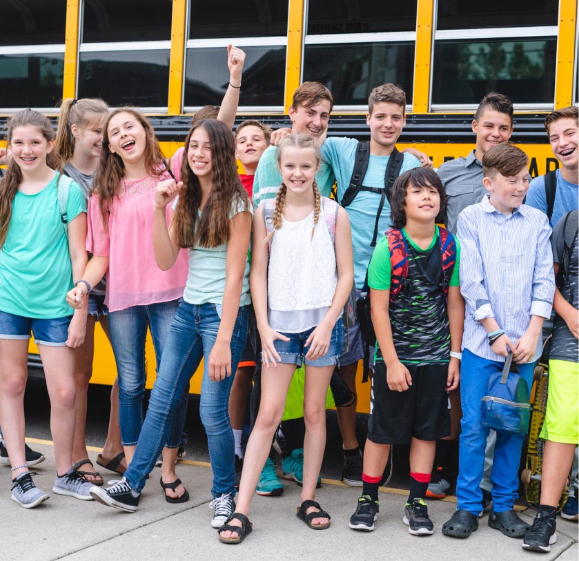 School group arriving by charter bus at a hotel with a student trip room block