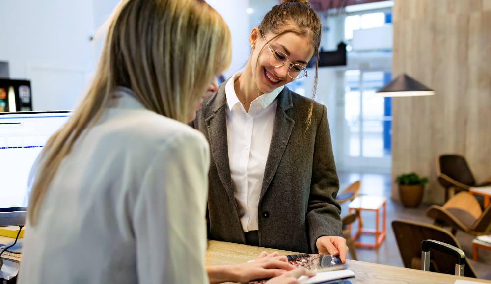Business travelers checking in on a corporate negotiated hotel rate