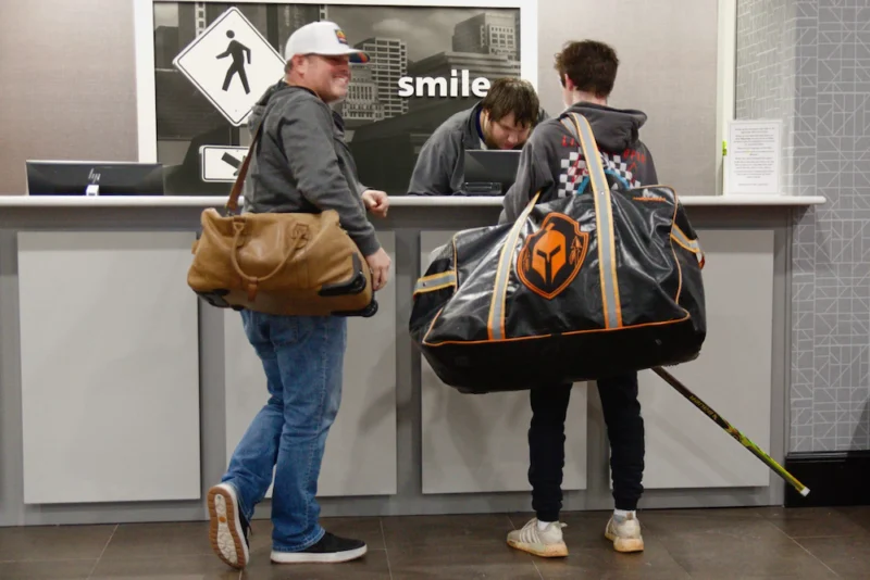 Youth sports team arriving at a tournament hotel with a room block